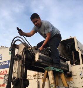 carlos repairing an ADS garbage truck