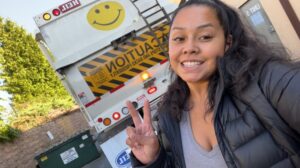 erica posing with the ADS garbage truck